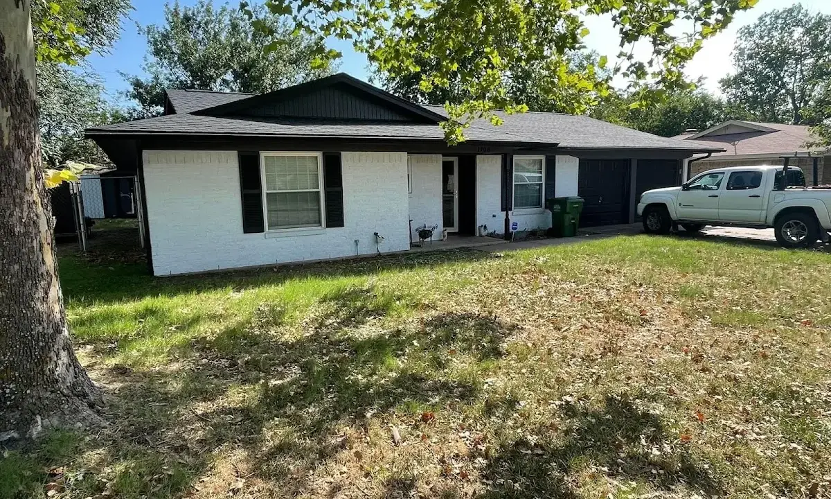 Professional roofing crew working on a residential roof in Leland